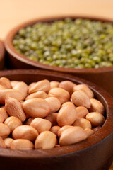 Raw Peanut in wooden bowl. Close-up