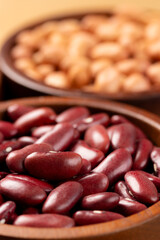 Raw red kidney beans in wooden bowl. Close-up