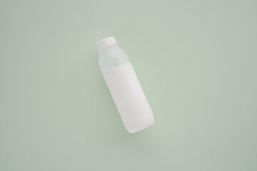 Minimalist White Bottle on Pastel Green Background