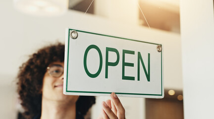 Waiter, man and open sign in small business cafe for public notice, start day and shop advertisement. Storefront, barista and signage on window for welcome message, hospitality and ready for service