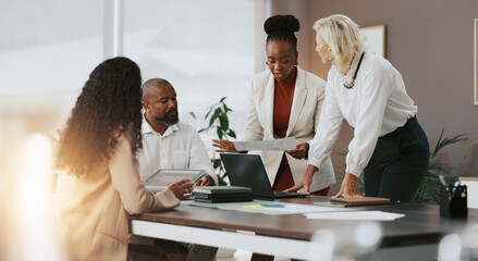 Laptop, paperwork and meeting with business people in office for strategy, teamwork and research. Company growth, market report and brainstorming with employees in agency for discussion and planning