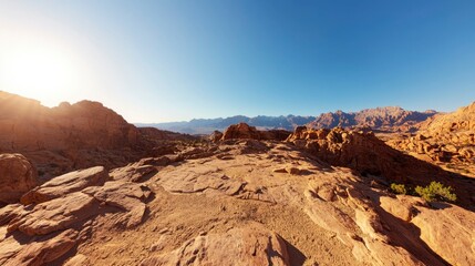 Fototapeta premium Sunlit desert landscape, rocky terrain, vast expanse, clear sky