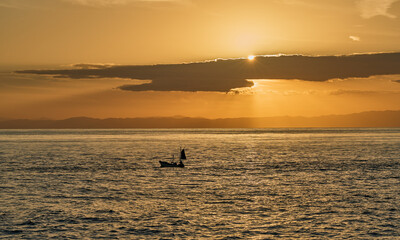 Fototapeta premium Seascape at Sunset - Calm Seas and Homeward-bound Boat