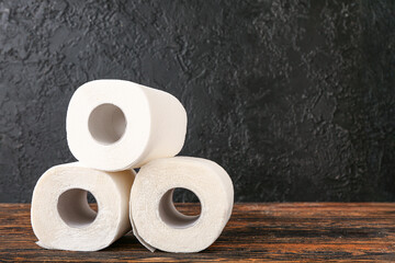 Rolls of toilet paper on wooden table