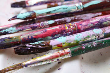 Dirty paint brushes on white background