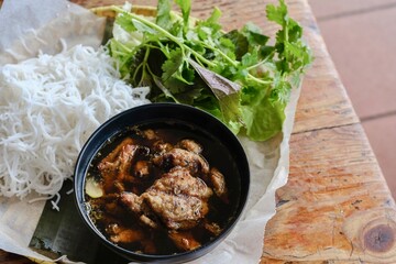 Bun cha Hanoi with grilled pork meatballs and a basket of fresh herbs and rice noodles at VN Street Foods, a North Vietnamese street food restaurant in Sydney’s inner west - Marrickville, NSW 