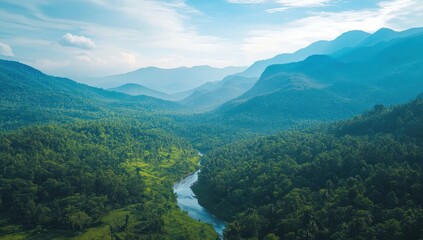 Serene Mountains and Lush Green Forest with a Winding River Under a Bright Sky at Sunrise in a Remote Wilderness Landscape