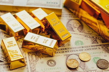 Gold bars on the background of dollar bills. The concept of wealth