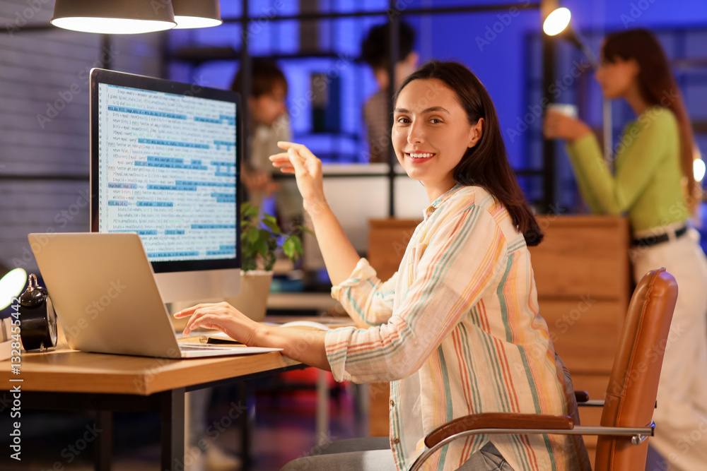 Poster female programmer working with computer in office at night