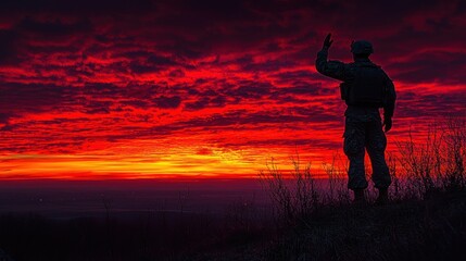 Soldier saluting fiery sunset, hilltop vigil