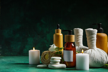 Spa composition with cosmetic products, spa accessories and flowers on dark color background
