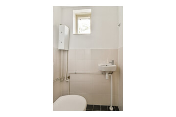 A compact bathroom featuring a clean design with white tiles, a small sink, and a window allowing natural light. Ideal for minimalist aesthetics.