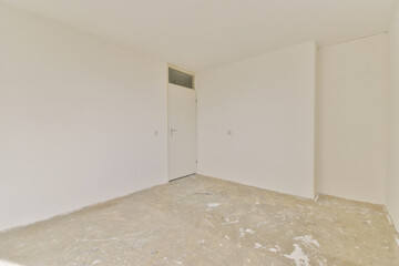 A spacious and minimalist interior showcasing plain white walls and an unfinished floor, providing a clean and open atmosphere for various uses.