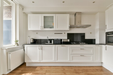 A sleek and contemporary kitchen equipped with modern appliances and a minimalist aesthetic...