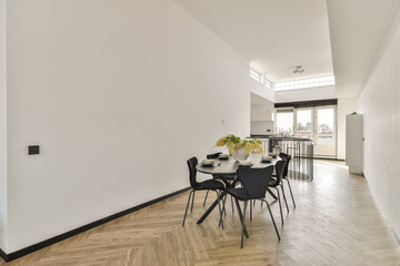 Bright and airy dining area featuring stylish furniture, ample natural light, and a minimalist aesthetic, perfect for modern living.