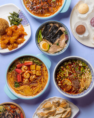 Chinese ready meals on a blue table. A wide variety of Asian dishes