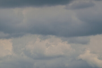The dark sky with heavy clouds converging and a violent storm before the rain.Bad or moody weather sky and environment. carbon dioxide emissions, greenhouse effect, global warming, climate change.