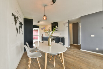 A stylish dining room featuring a sleek table, elegant chairs, and a world map mural, creating a contemporary vibe and inviting atmosphere.