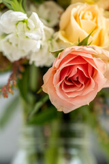 Detailed up close portrait of peach rose in floral arrangement