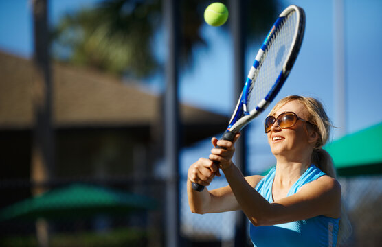 Woman practicing tennis at the tennis court
