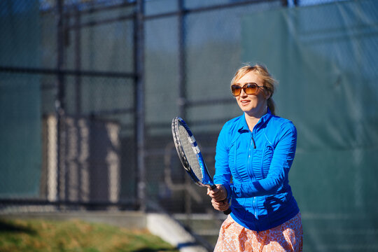 Woman practicing tennis at the tennis court