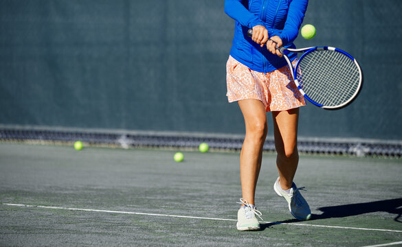 Woman practicing tennis at the tennis court