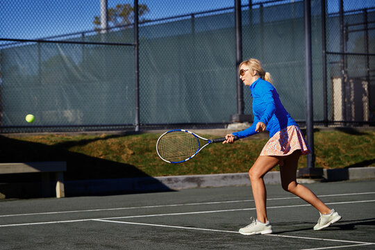 Woman practicing tennis at the tennis court
