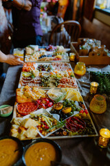 A vibrant charcuterie board with cheeses, olives, and dips