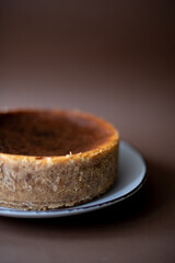 Homemade cheesecake on a brown background