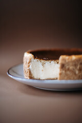 sliced ​​cheesecake close-up on a brown background