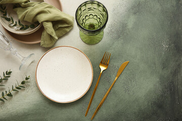 Beautiful table setting with eucalyptus branches on grunge background