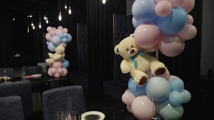 Pink and blue balls with a teddy bear at a gender party in a restaurant. Gender party balls pink and blue.