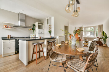 Spacious kitchen and dining area featuring contemporary decor, natural lighting, and stylish furniture that enhances the ambiance of the space.