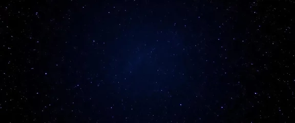 Fototapeten Seamless loop of twinkling stars in a dark, starry night sky, glowing with blue starlight, blinking, galaxy © Naksit
