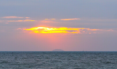 Sunset light shines through the clouds with island background