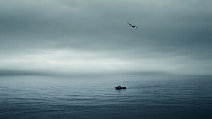 Naklejka premium Distant fishing boat sails on a foggy ocean with bird flying; for travel blog use