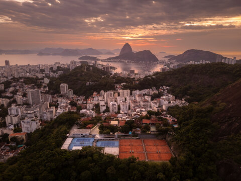 Beautiful aerial view to city buildings and streets with sun ris