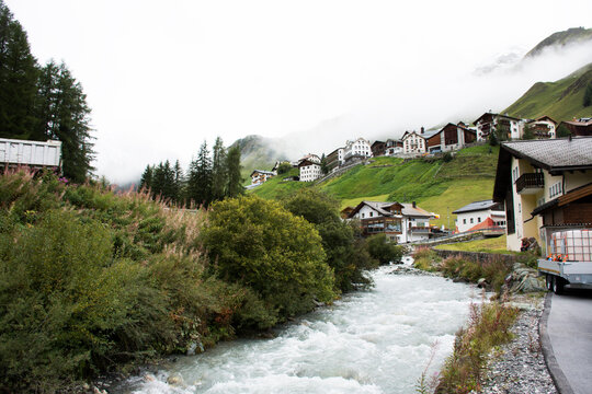 Stream and Glacier from Alps highest and most extensive mountain range flowing passed at Villages of Tschlin and Ramosch in Switzerland