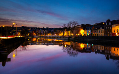 Obraz premium Cork, Ireland - March 6th 2025 - sunset view of buildings along the River Lee