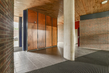 A contemporary interior space showcasing a blend of wooden and brick materials, emphasizing...