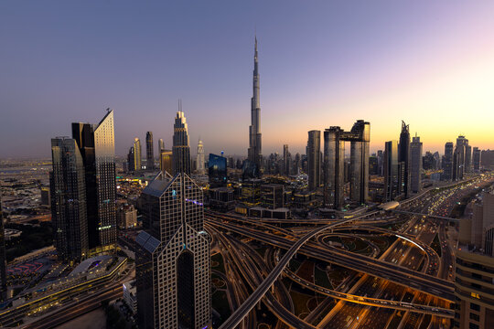 Modern city skyline and cityscape at sunset in Dubai UAE. - Powered by Adobe