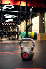 Kettlebells on a grass floor in the gym.