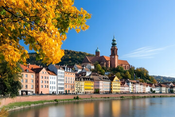 Obraz premium Colorful riverside town with autumn foliage and church
