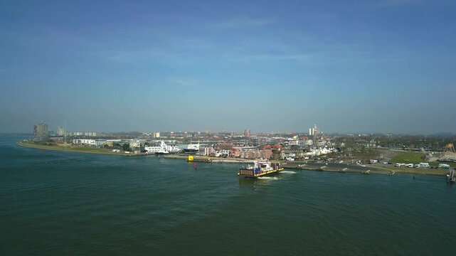 Drone view of a ferry leaving the port in Scheur River heading to Rozenburg on a sunny day