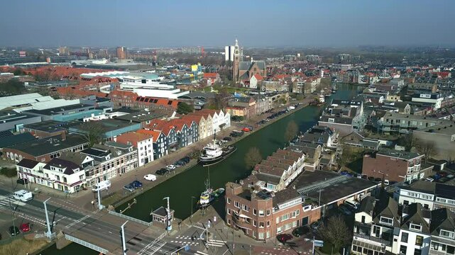 Drone footage of The inner harbor of Maassluis with the urban surroundings under blue sky