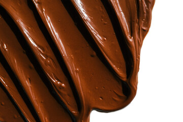 Smooth and glossy chocolate spread smeared on a white surface. The rich brown color and creamy texture highlight the indulgent nature of the sweet dessert ingredient, perfect for baking or spreading