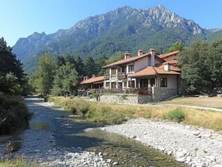 Naklejka premium Mountain resort homes beside a river.