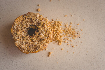Stack of dried apple slices with crushed nuts on top. Healthy homemade fruit chips with nuts on light background. Natural organic snack, vegetarian food, diet dessert, close-up