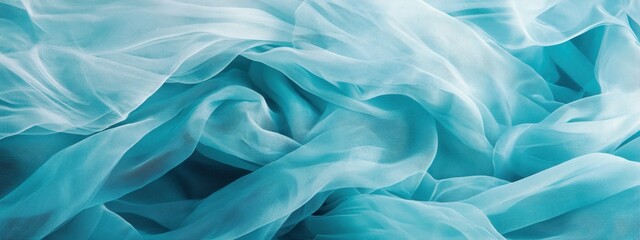 Obraz premium Soft Waves of Sheer Aqua Fabric Draped Elegantly on a Surface