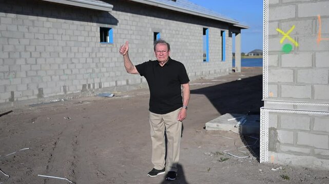 happy new construction home owner after a walk-through inspection before partial loan payment